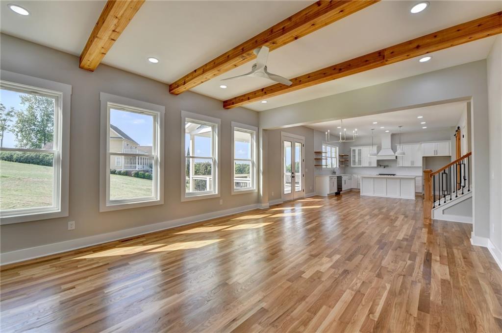 982 Wildberry Court Jefferson, GA 30549 - Photo 17 of 64 a view of an empty room with wooden floor and a window