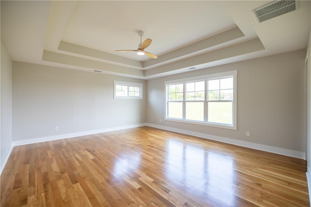 982 Wildberry Court Jefferson, GA 30549 - Photo 29 of 64 an empty room with wooden floor and windows