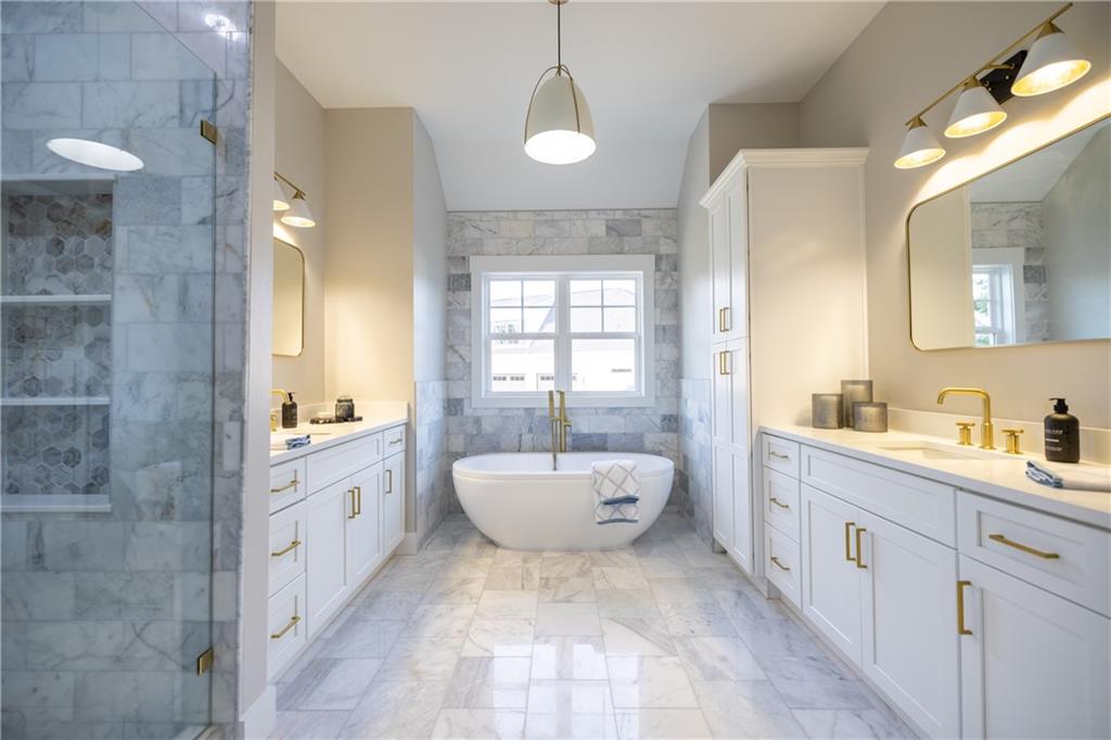 982 Wildberry Court Jefferson, GA 30549 - Photo 31 of 64 a bathroom with a granite countertop sink a toilet a mirror and bathtub