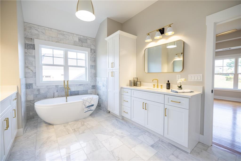 982 Wildberry Court Jefferson, GA 30549 - Photo 32 of 64 a spacious bathroom with a double vanity sink mirror and bathtub