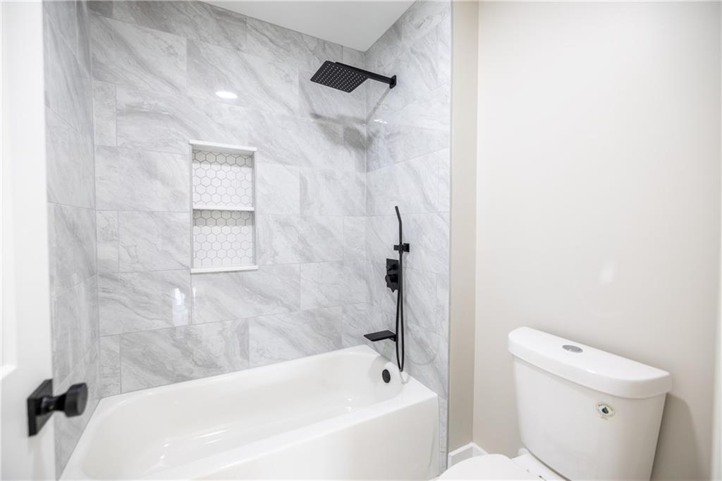 982 Wildberry Court Jefferson, GA 30549 - Photo 36 of 64 a bathroom with a bathtub and a toilet