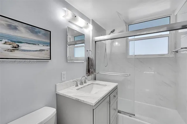 a bathroom with a sink toilet and vanity