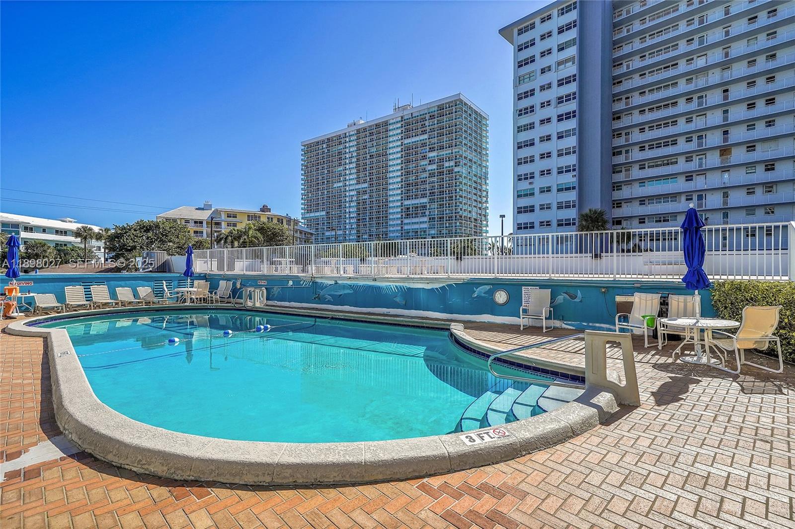 1900 South Ocean Drive, Unit 406 Fort Lauderdale, FL 33316 - Photo 24 of 26 a view of a swimming pool with outdoor seating