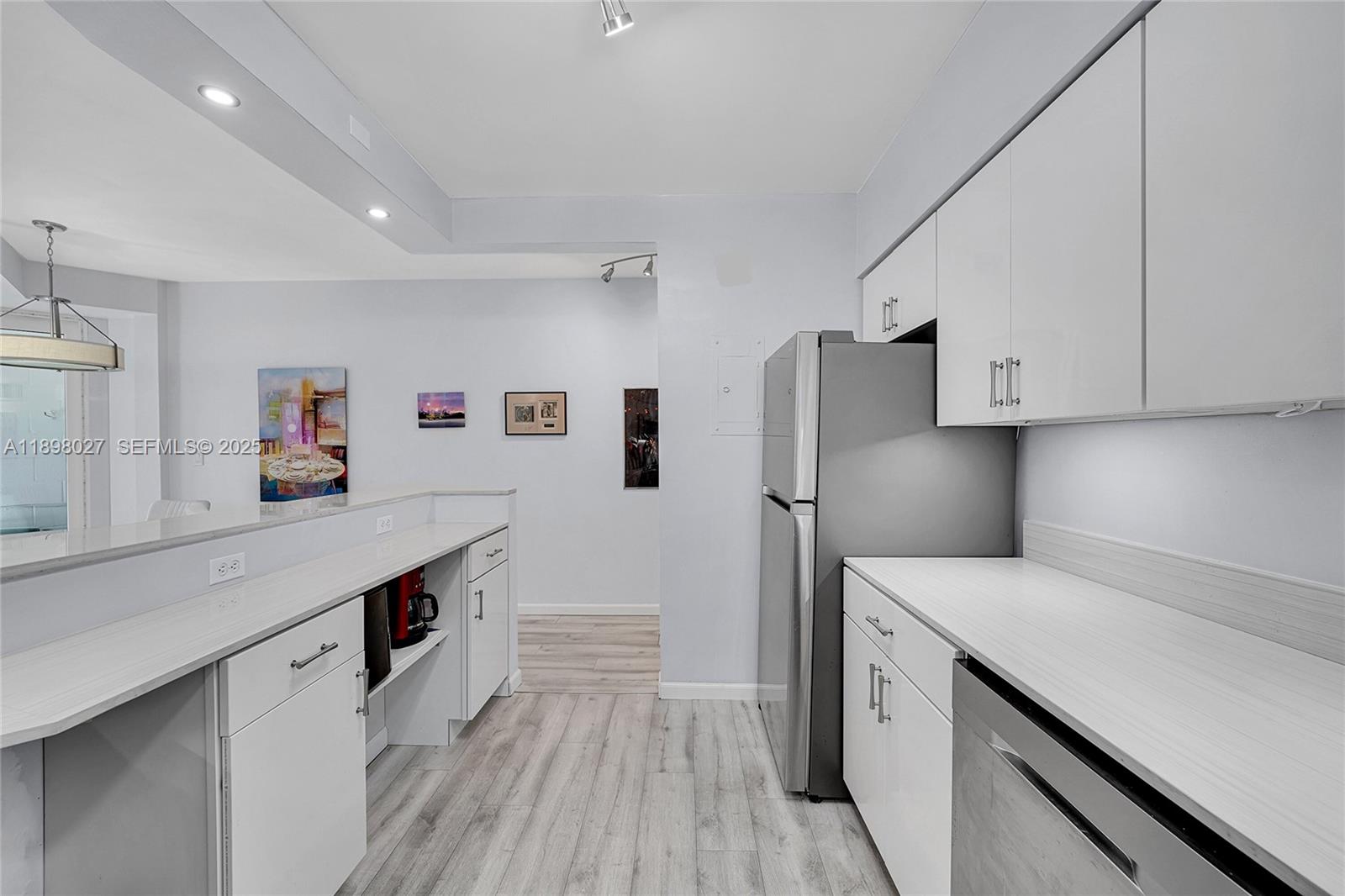 1900 South Ocean Drive, Unit 406 Fort Lauderdale, FL 33316 - Photo 3 of 26 a kitchen with stainless steel appliances a sink dishwasher stove refrigerator and cabinets