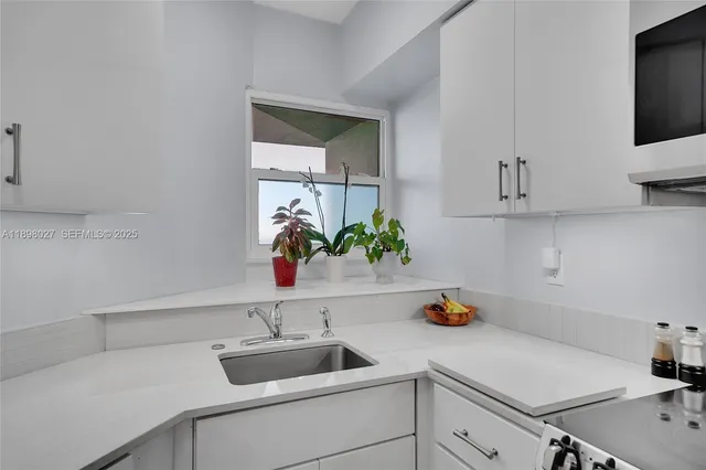 a kitchen with a sink and cabinets