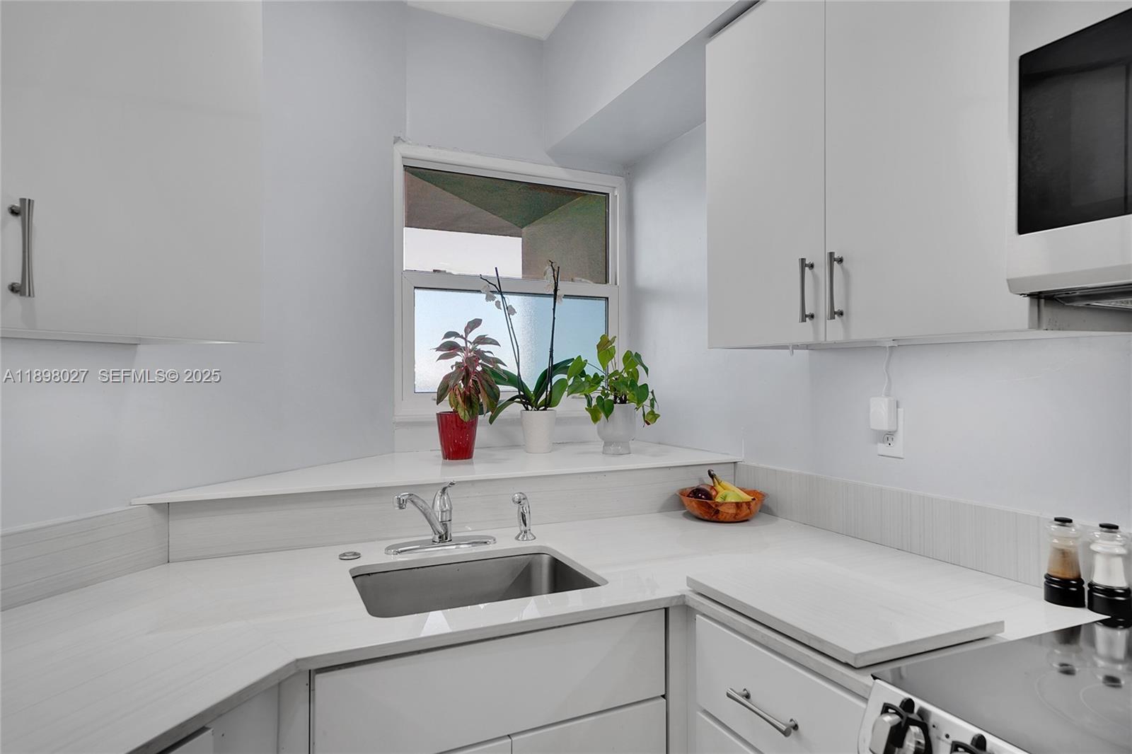 1900 South Ocean Drive, Unit 406 Fort Lauderdale, FL 33316 - Photo 5 of 26 a kitchen with a sink and cabinets
