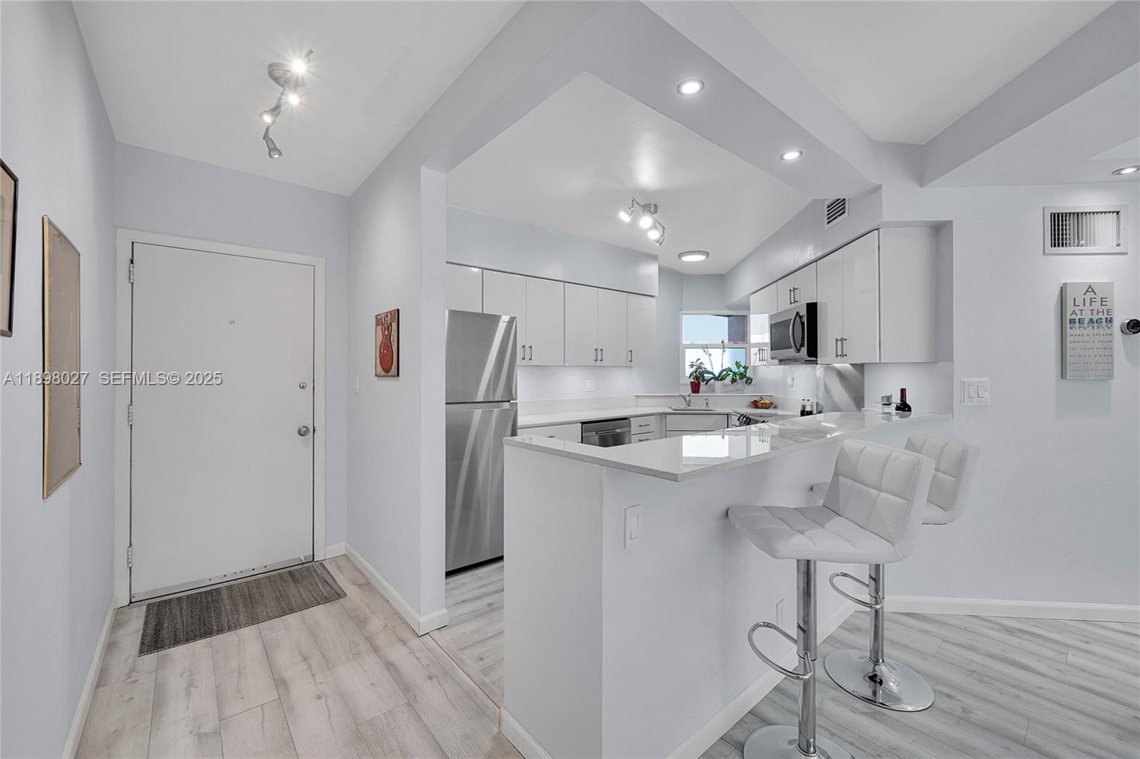 1900 South Ocean Drive, Unit 406 Fort Lauderdale, FL 33316 - Photo 6 of 26 a kitchen with stainless steel appliances a refrigerator sink and cabinets