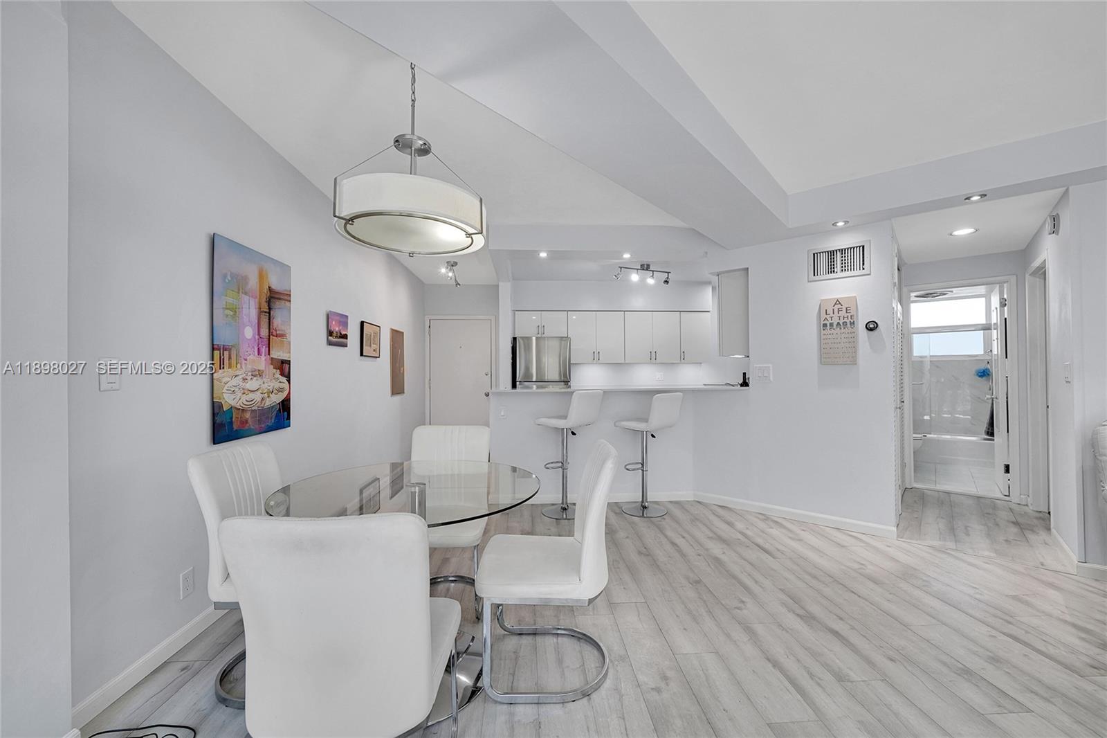 1900 South Ocean Drive, Unit 406 Fort Lauderdale, FL 33316 - Photo 9 of 26 a view of a dining room with furniture and wooden floor
