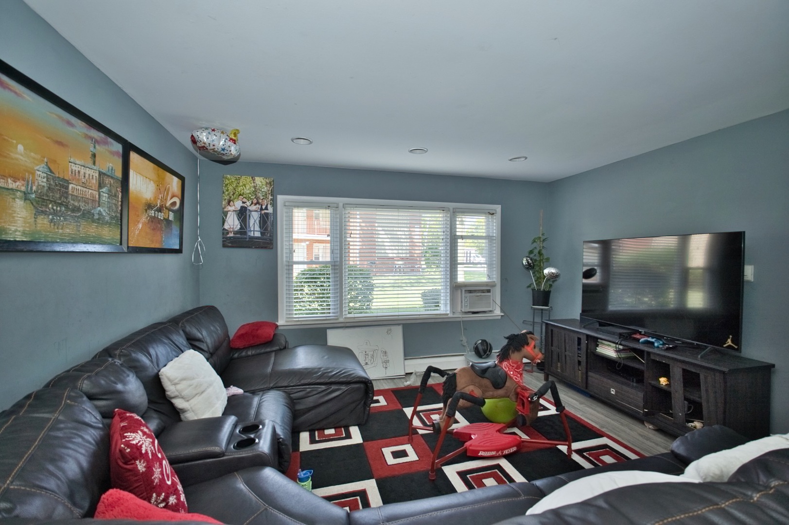 1111 East Algonquin Road, Unit 1 Arlington Heights, IL 60005 - Photo 14 of 42 a living room with furniture and a flat screen tv