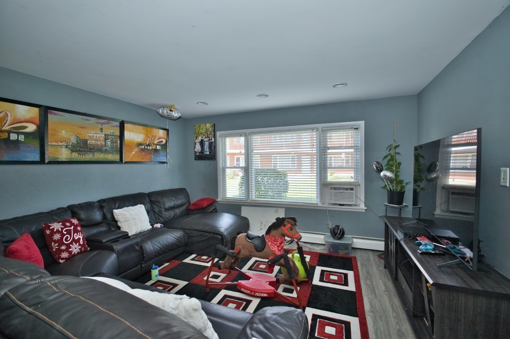 1111 East Algonquin Road, Unit 1 Arlington Heights, IL 60005 - Photo 15 of 42 a living room with furniture and a flat screen tv
