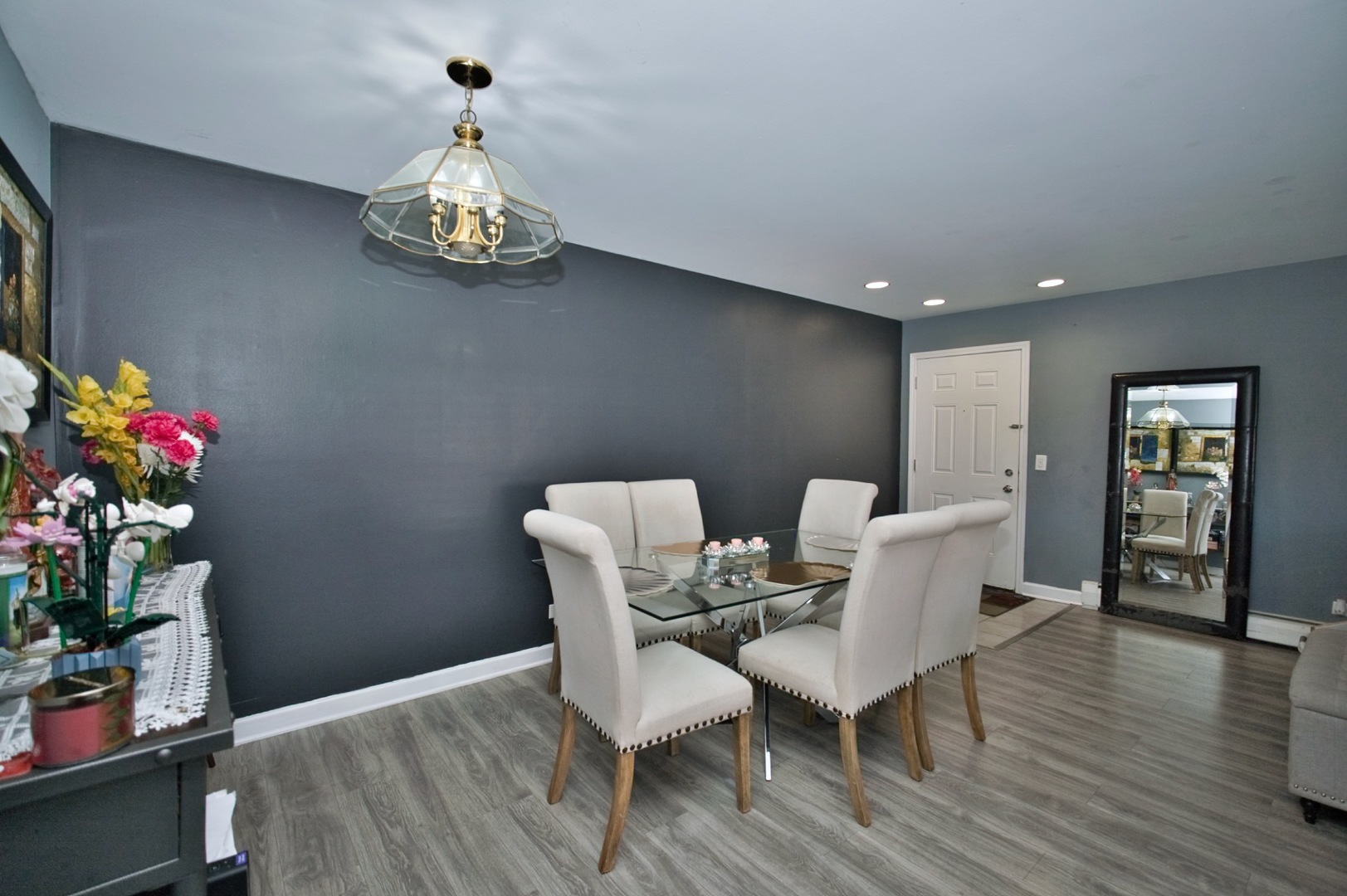 1111 East Algonquin Road, Unit 1 Arlington Heights, IL 60005 - Photo 19 of 42 a view of a dining room with furniture wooden floor and chandelier