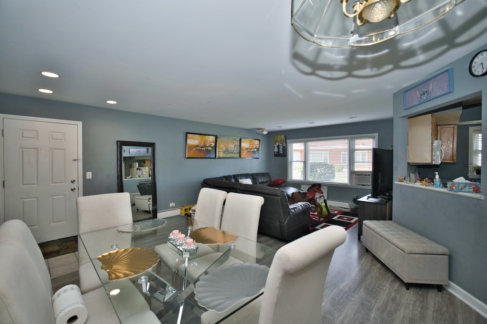 1111 East Algonquin Road, Unit 1 Arlington Heights, IL 60005 - Photo 21 of 42 a living room with furniture and a chandelier