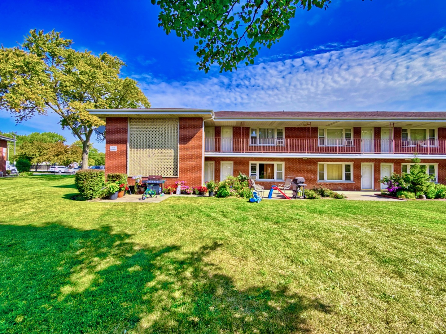 1111 East Algonquin Road, Unit 1 Arlington Heights, IL 60005 - Photo 3 of 42 a front view of a house with a yard