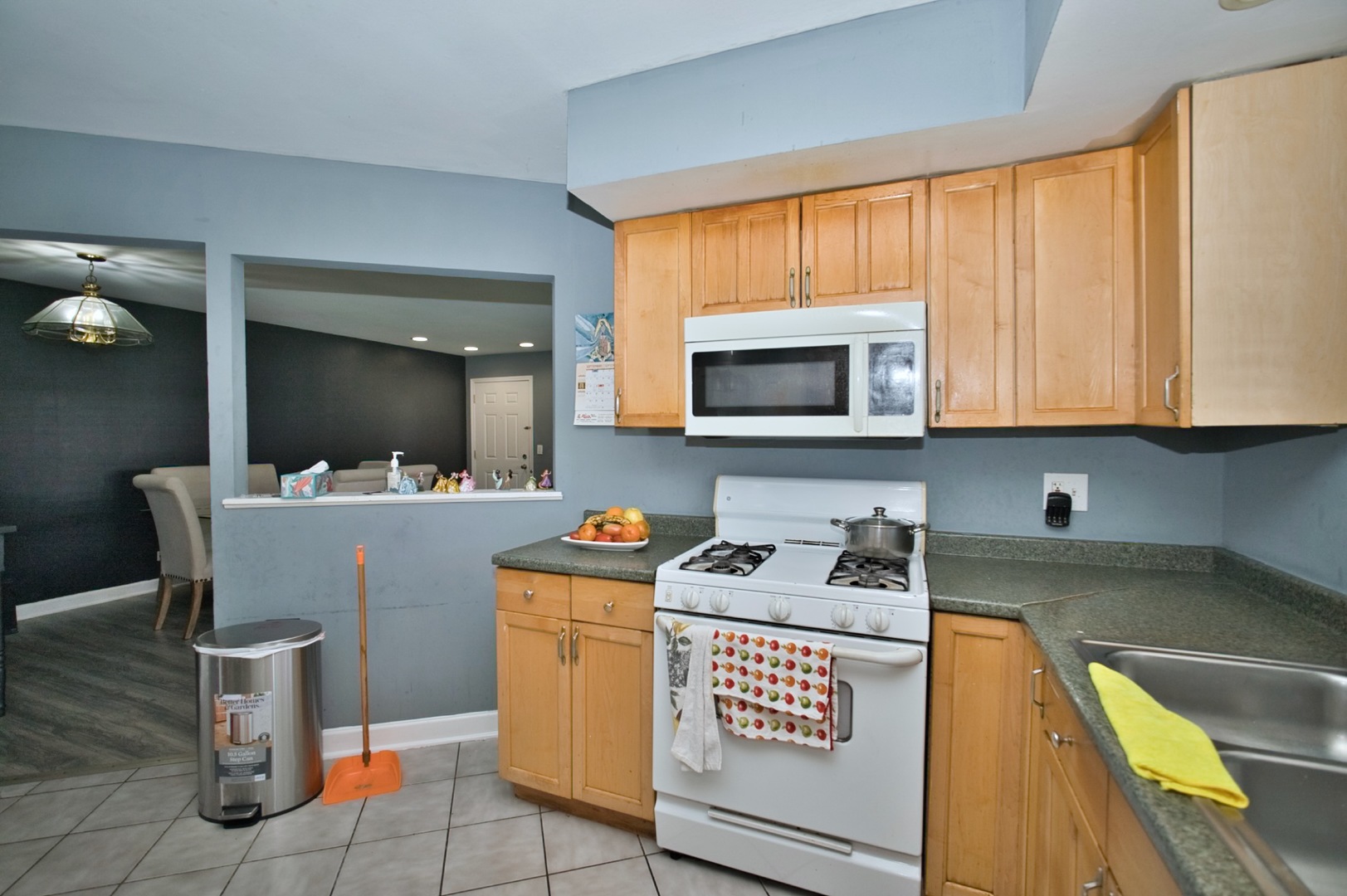 1111 East Algonquin Road, Unit 1 Arlington Heights, IL 60005 - Photo 31 of 42 a kitchen with a stove a sink and a microwave