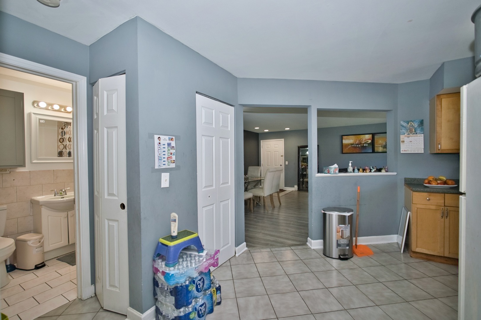 1111 East Algonquin Road, Unit 1 Arlington Heights, IL 60005 - Photo 32 of 42 a living room with furniture a flat screen tv and a dining table