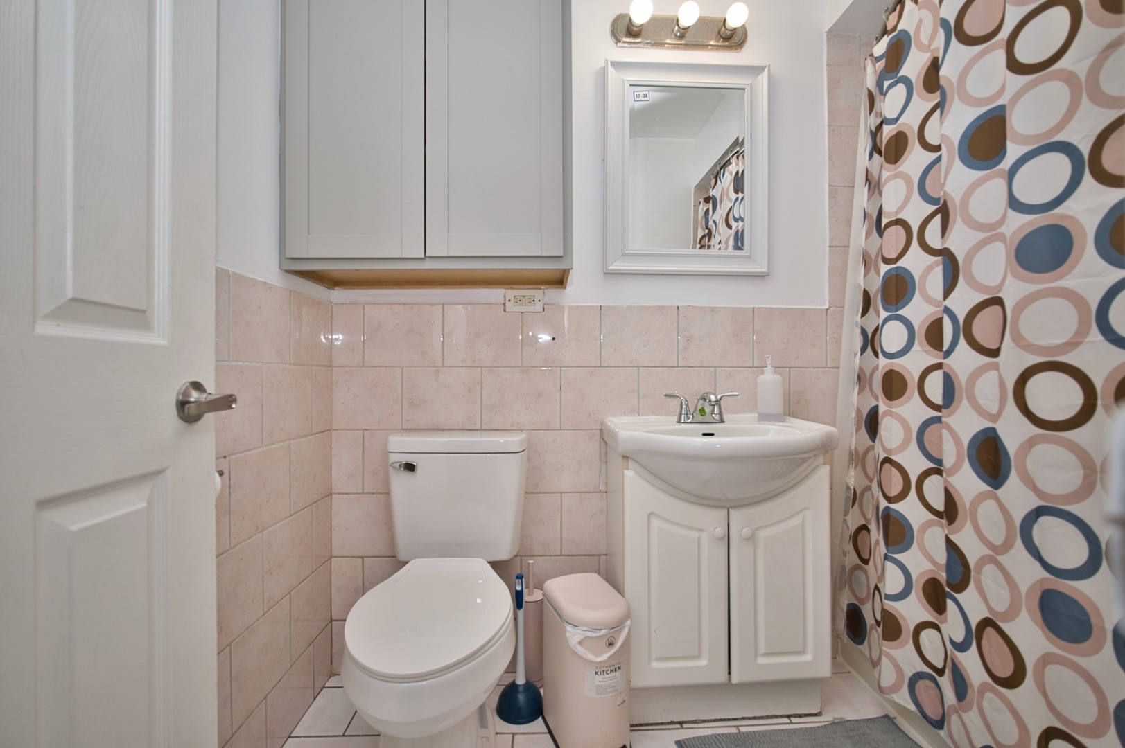 1111 East Algonquin Road, Unit 1 Arlington Heights, IL 60005 - Photo 34 of 42 a bathroom with a toilet sink and mirror