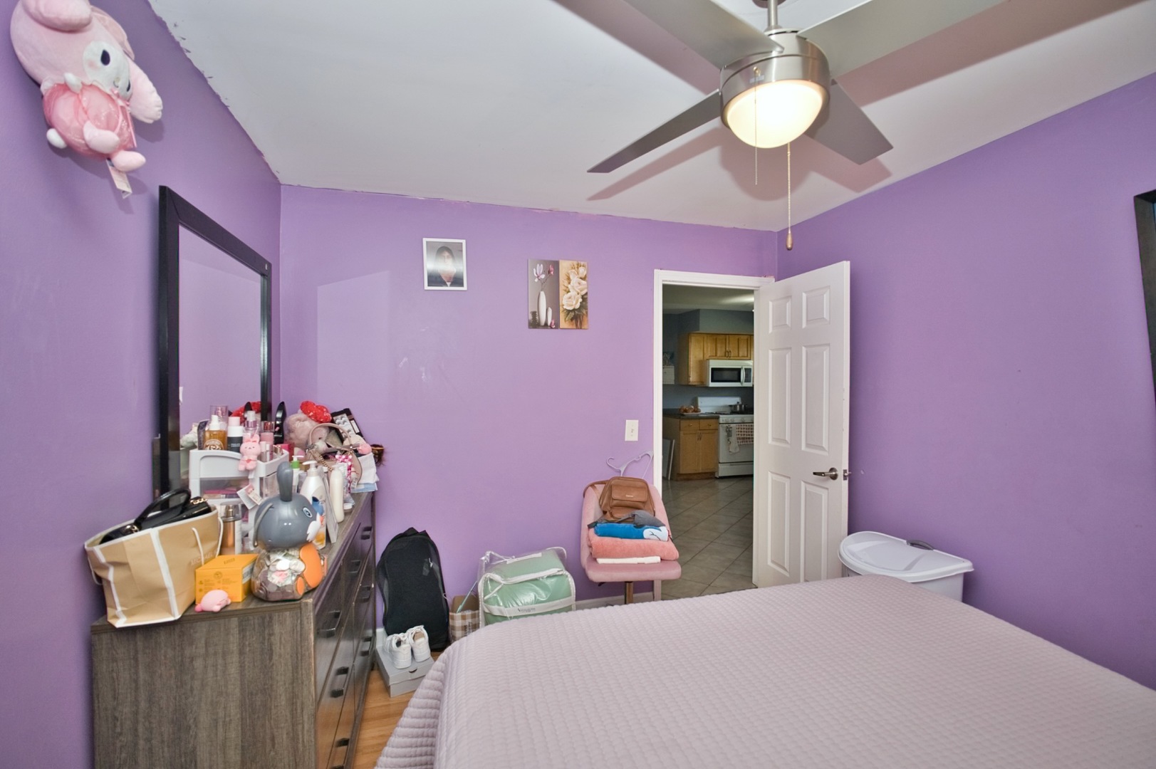 1111 East Algonquin Road, Unit 1 Arlington Heights, IL 60005 - Photo 38 of 42 a bedroom with a bed dresser and a chandelier