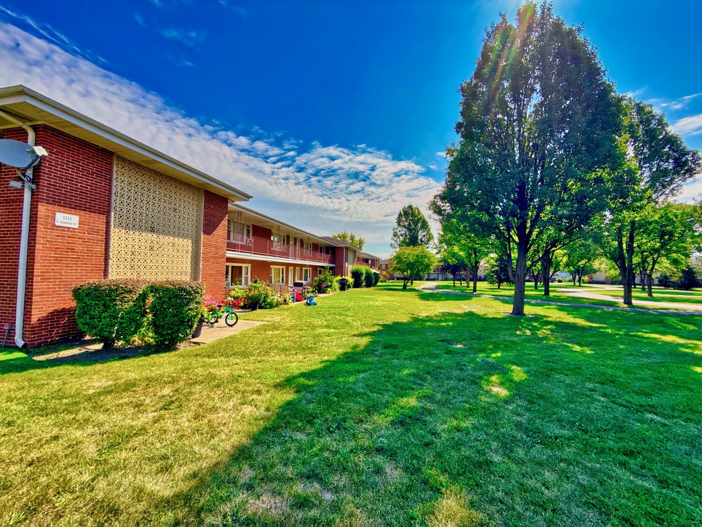 1111 East Algonquin Road, Unit 1 Arlington Heights, IL 60005 - Photo 4 of 42 a front view of a house with garden