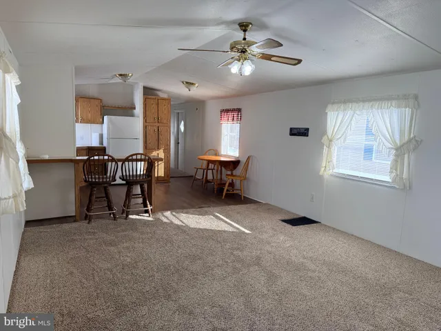 a view of a livingroom with furniture and a window