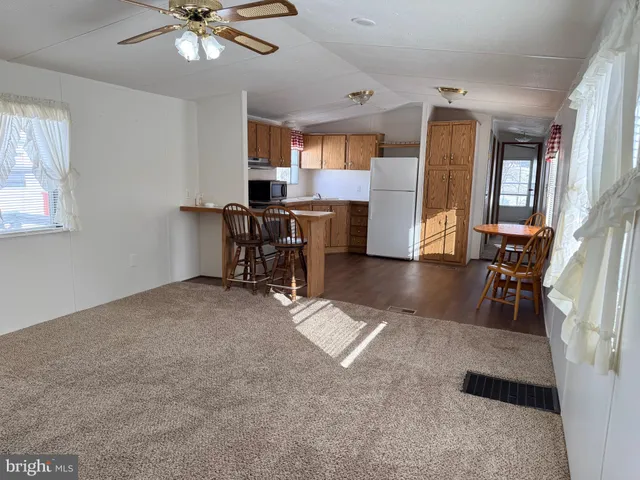 a view of a livingroom with furniture and a workspace