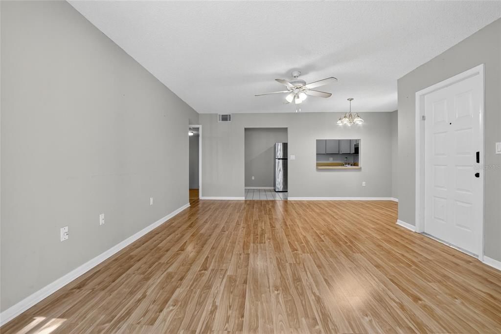 1225 Pine Ridge Circle West, Unit A2 Tarpon Springs, FL 34688 - Photo 12 of 59 wooden floor in an empty room with a window