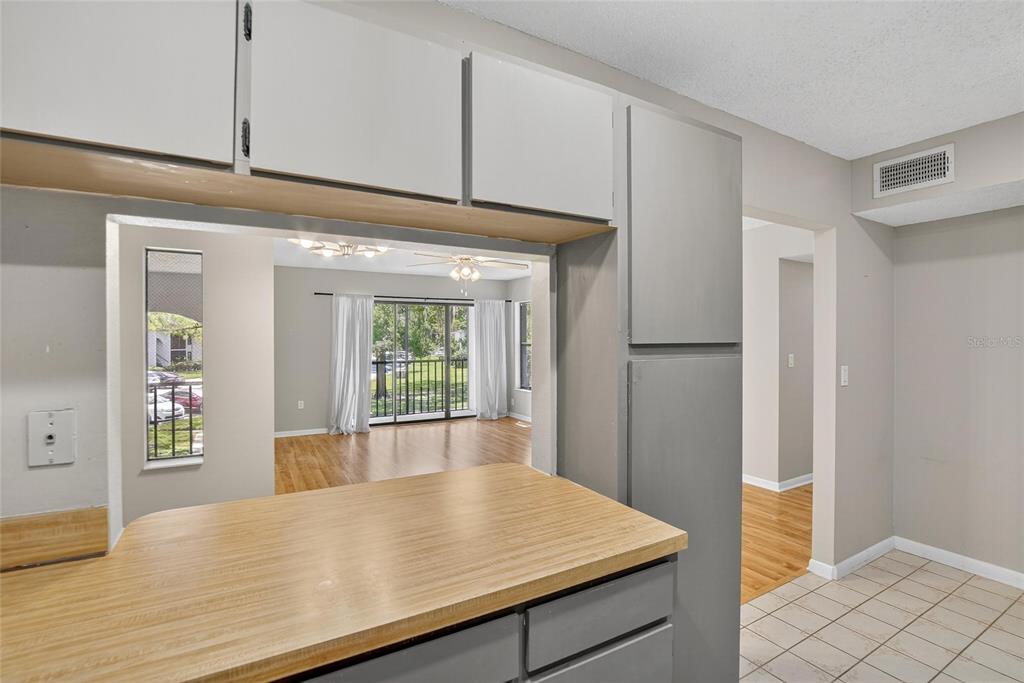 1225 Pine Ridge Circle West, Unit A2 Tarpon Springs, FL 34688 - Photo 16 of 59 a view of kitchen with furniture and wooden floor