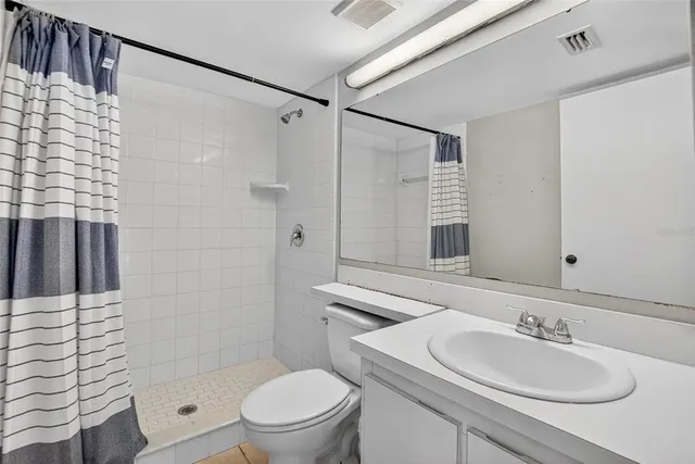 a view of a bathroom with a shower and a toilet