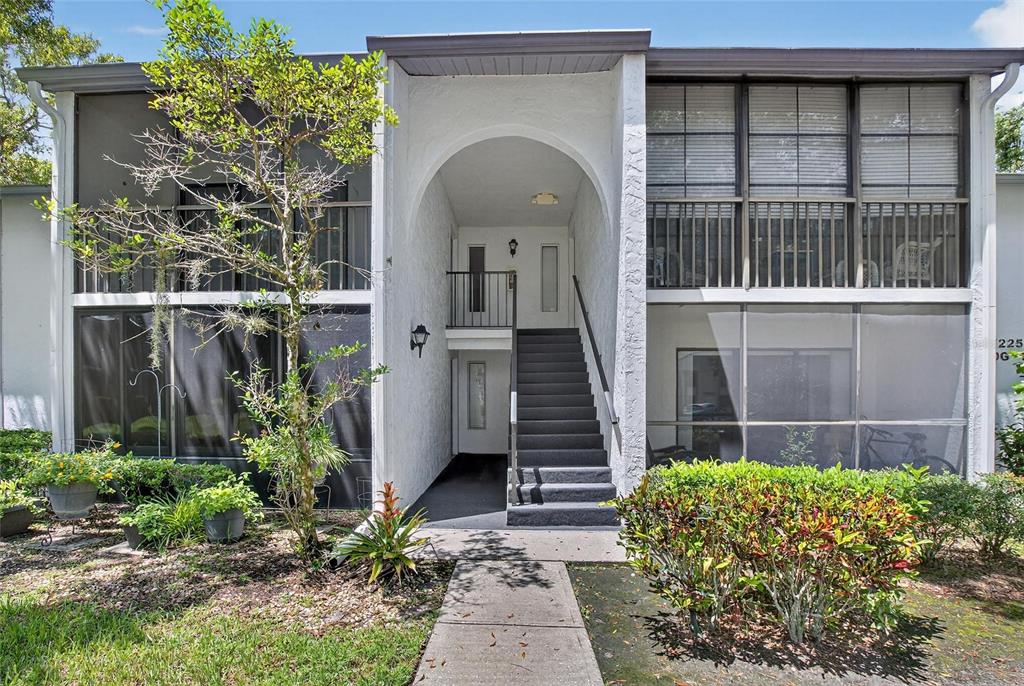 1225 Pine Ridge Circle West, Unit A2 Tarpon Springs, FL 34688 - Photo 2 of 59 a front view of a house with a yard