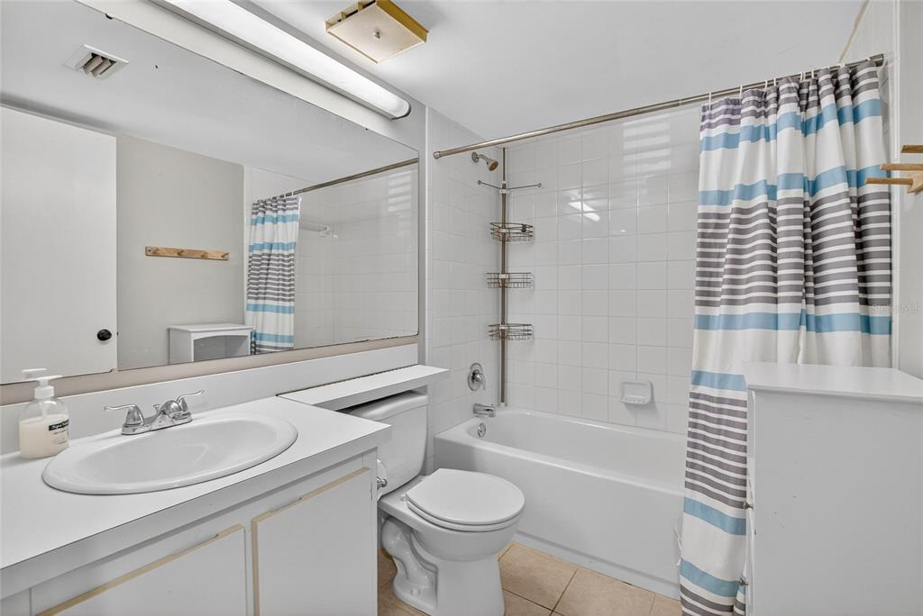 1225 Pine Ridge Circle West, Unit A2 Tarpon Springs, FL 34688 - Photo 27 of 59 a bathroom with a sink toilet vanity and shower