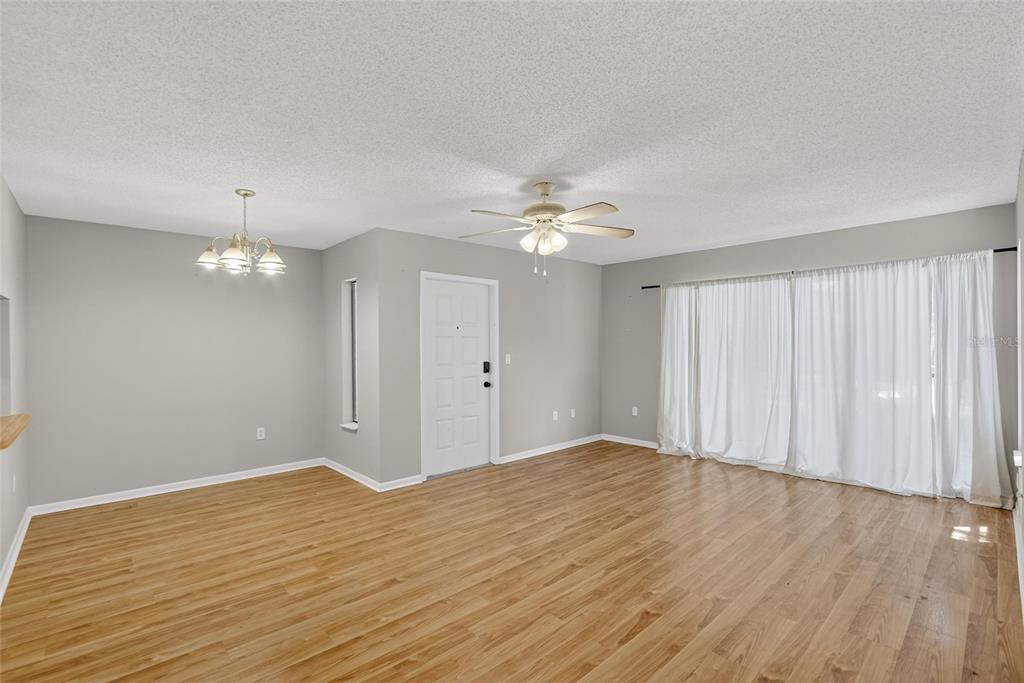 1225 Pine Ridge Circle West, Unit A2 Tarpon Springs, FL 34688 - Photo 29 of 59 a view of an empty room with wooden floor