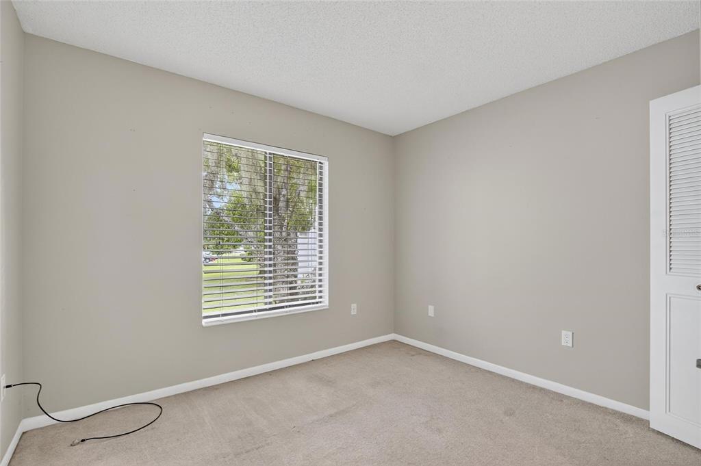 1225 Pine Ridge Circle West, Unit A2 Tarpon Springs, FL 34688 - Photo 30 of 59 a view of an empty room with a window
