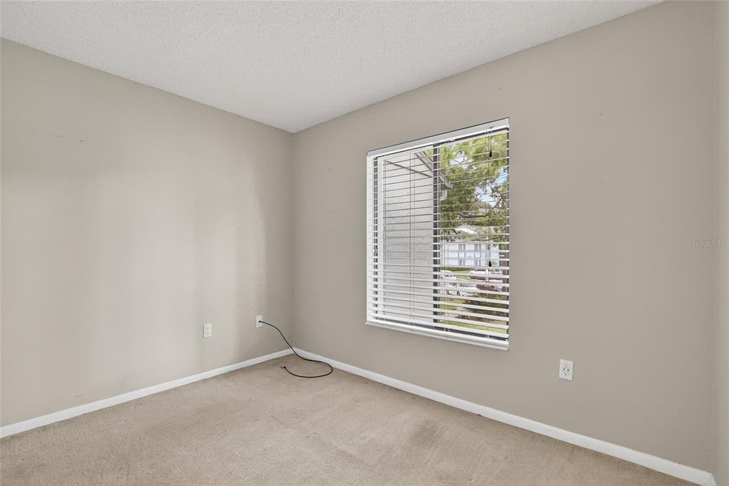 1225 Pine Ridge Circle West, Unit A2 Tarpon Springs, FL 34688 - Photo 33 of 59 an empty room with windows