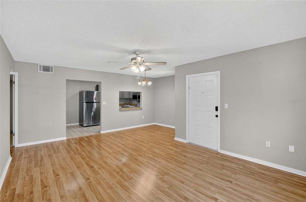 1225 Pine Ridge Circle West, Unit A2 Tarpon Springs, FL 34688 - Photo 45 of 59 a view of a livingroom with a chandelier