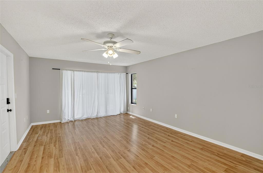 1225 Pine Ridge Circle West, Unit A2 Tarpon Springs, FL 34688 - Photo 47 of 59 a view of an empty room with wooden floor