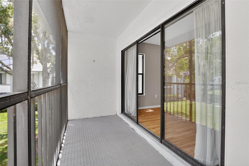1225 Pine Ridge Circle West, Unit A2 Tarpon Springs, FL 34688 - Photo 49 of 59 a view of a glass door and porch