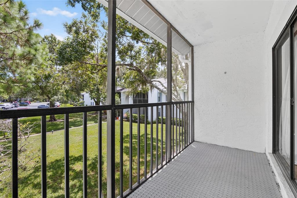1225 Pine Ridge Circle West, Unit A2 Tarpon Springs, FL 34688 - Photo 50 of 59 a view of a balcony with wooden floor