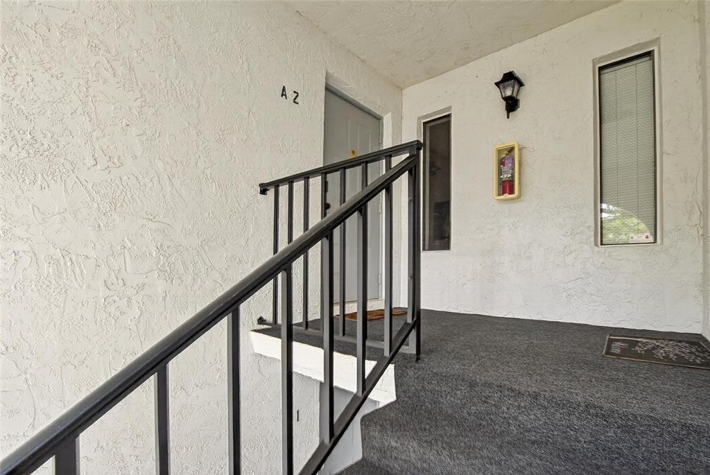 1225 Pine Ridge Circle West, Unit A2 Tarpon Springs, FL 34688 - Photo 8 of 59 a view of staircase with railing and white walls