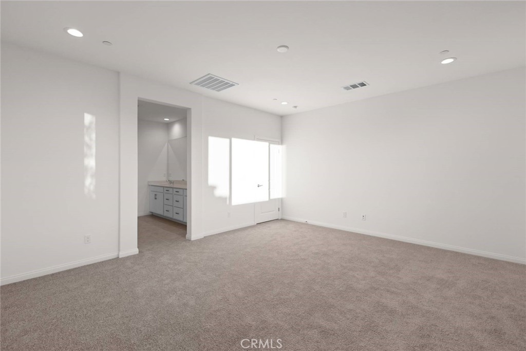 17727 Santa Lucia Court Riverside, CA 92503 - Photo 25 of 42 an empty room with windows and pillars in it