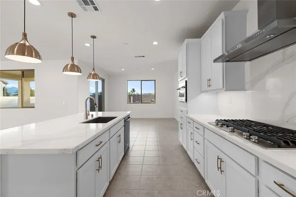 a kitchen with white cabinets and appliances
