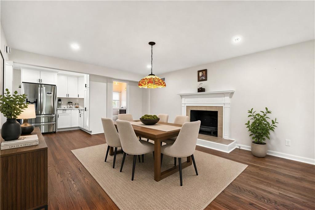 736 Pinetree Road Pittsburgh, PA 15243 - Photo 12 of 43 The spacious dining room is designed with entertaining in mind, offering plenty of room for large gatherings as well as a comfortable conversation area, all centered around a cozy fireplace. Photo is digitally staged.
