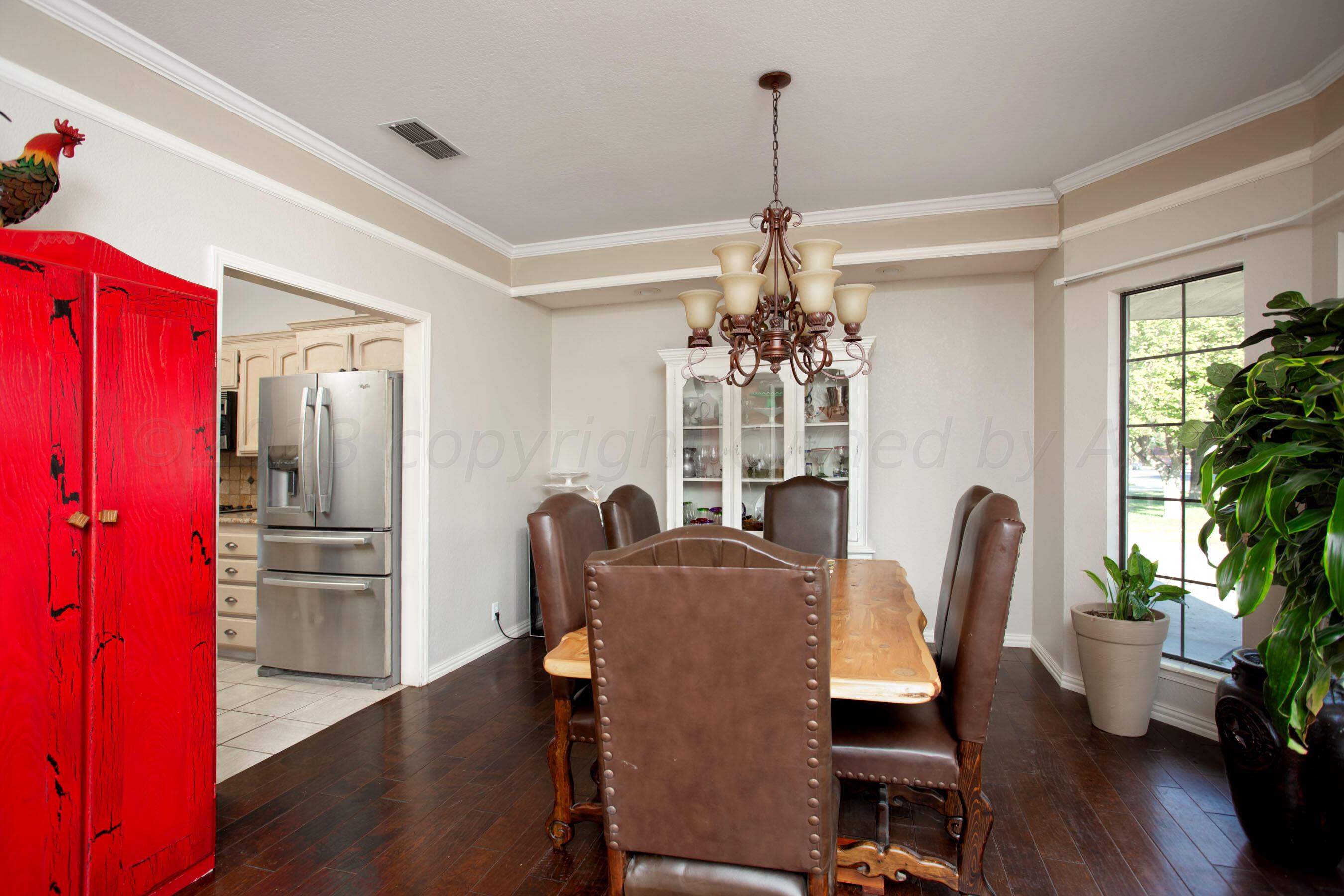 7301 Smoketree Drive Amarillo, TX 79124 - Photo 12 of 37 a view of a dining room with furniture window and wooden floor