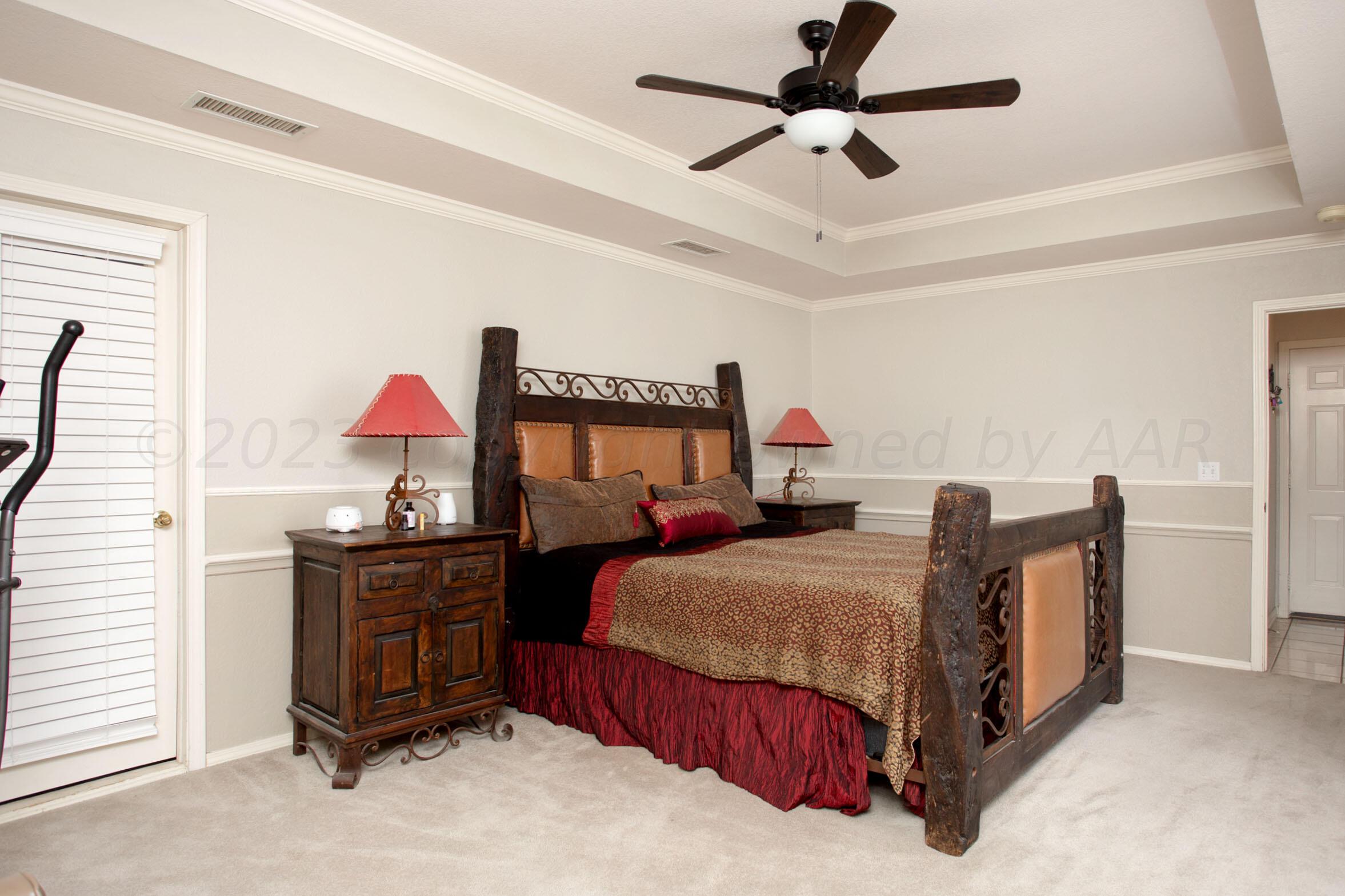 7301 Smoketree Drive Amarillo, TX 79124 - Photo 19 of 37 a bedroom with a bed dresser and a window
