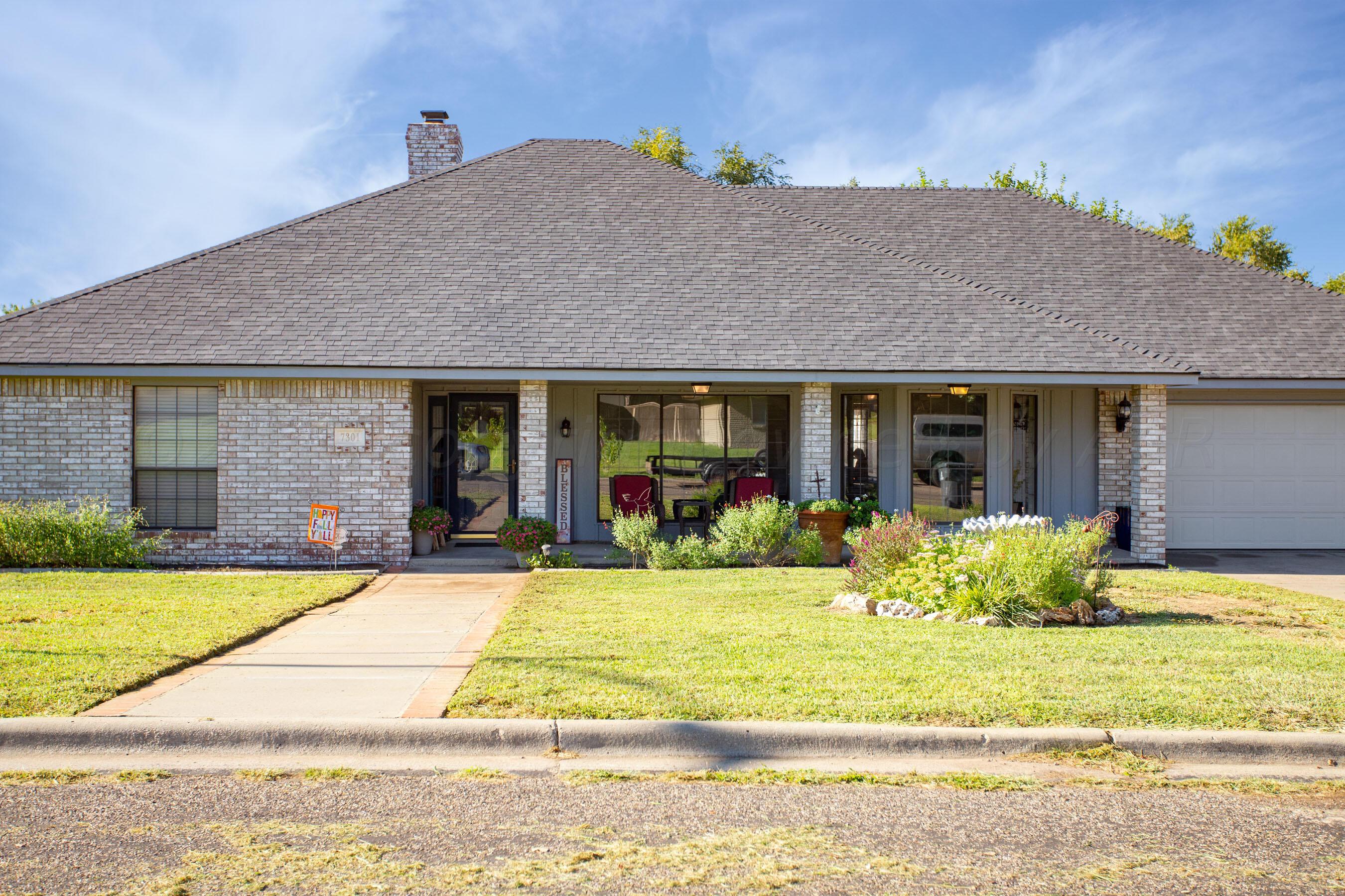 7301 Smoketree Drive Amarillo, TX 79124 - Photo 2 of 37 a front view of a house with swimming pool and porch with furniture