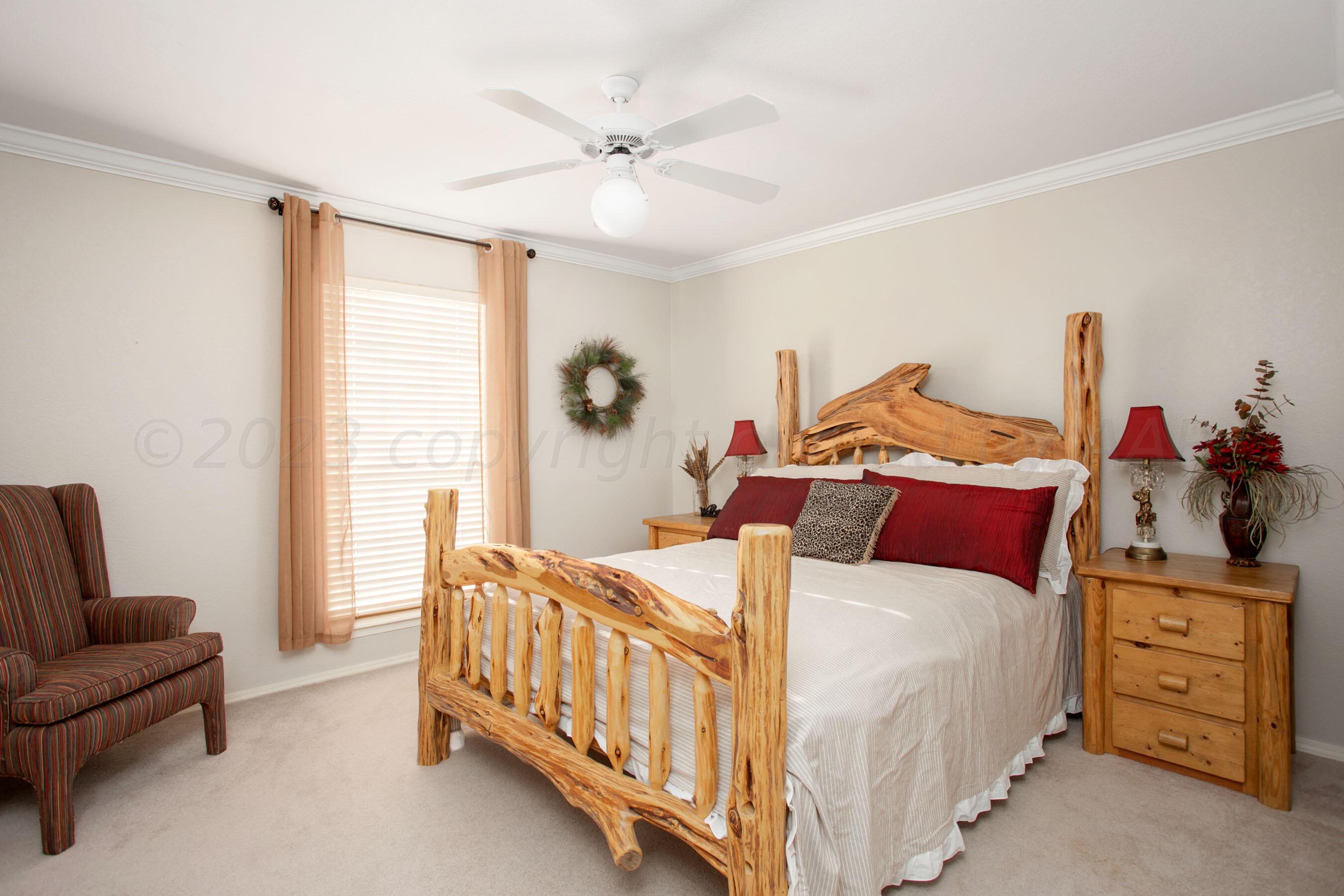 7301 Smoketree Drive Amarillo, TX 79124 - Photo 26 of 37 a bedroom with a bed a couch and dresser