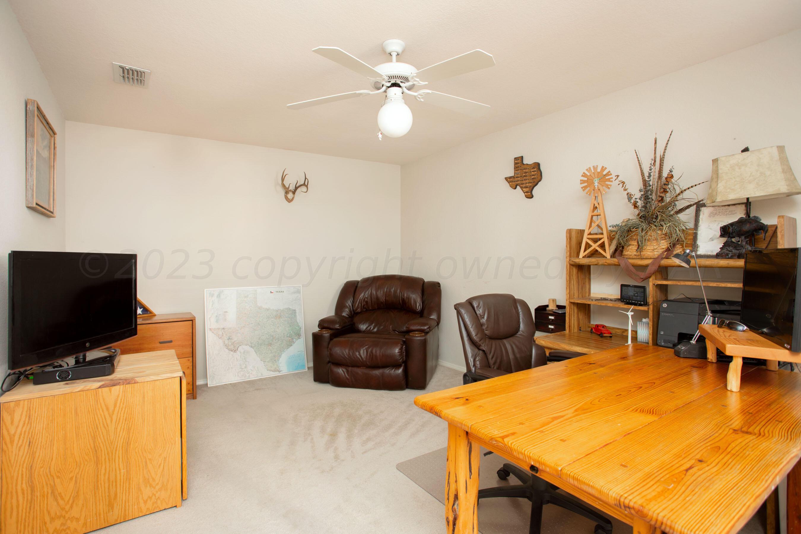 7301 Smoketree Drive Amarillo, TX 79124 - Photo 29 of 37 a room with furniture and flat screen tv