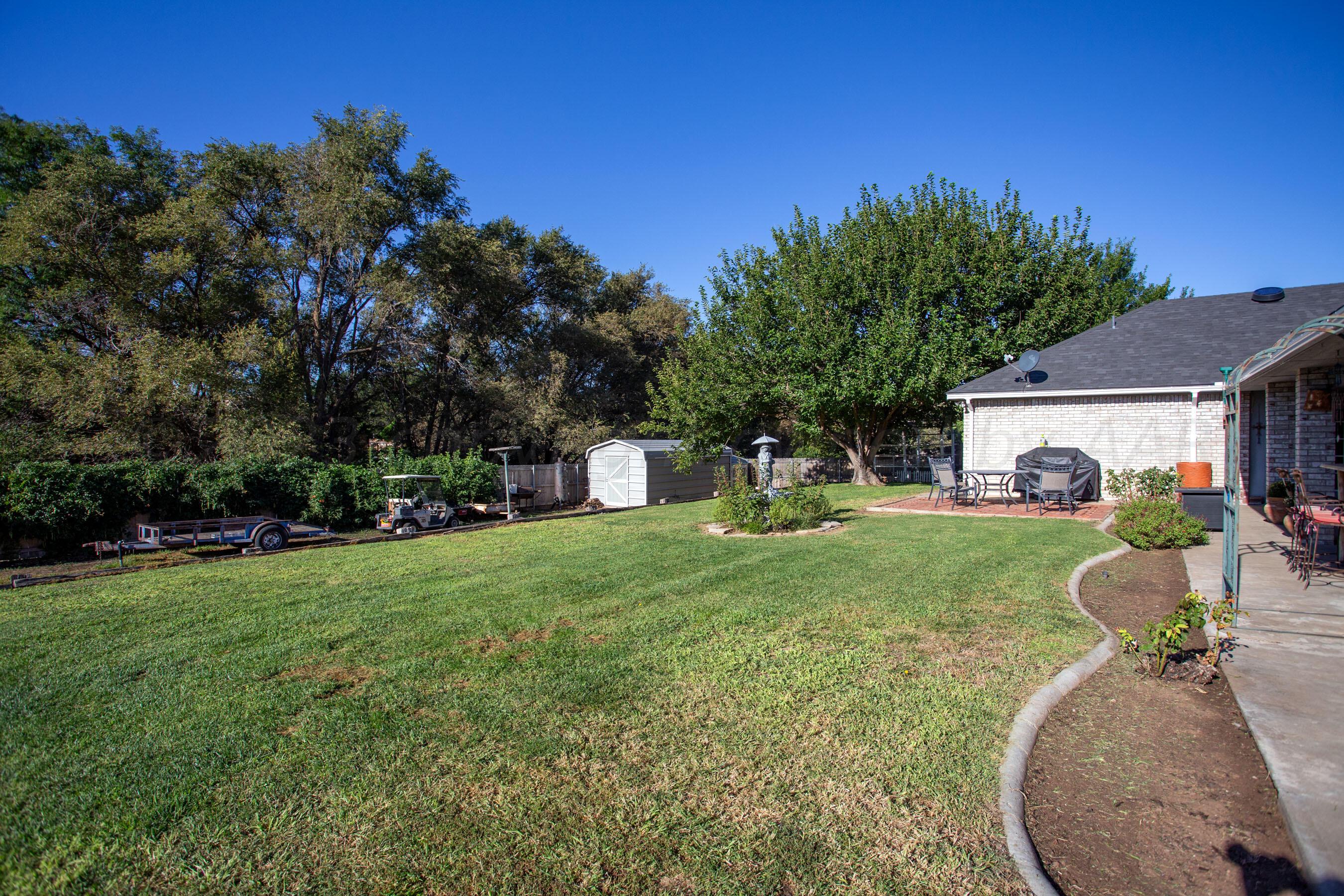 7301 Smoketree Drive Amarillo, TX 79124 - Photo 34 of 37 a front view of a house with a garden and porch