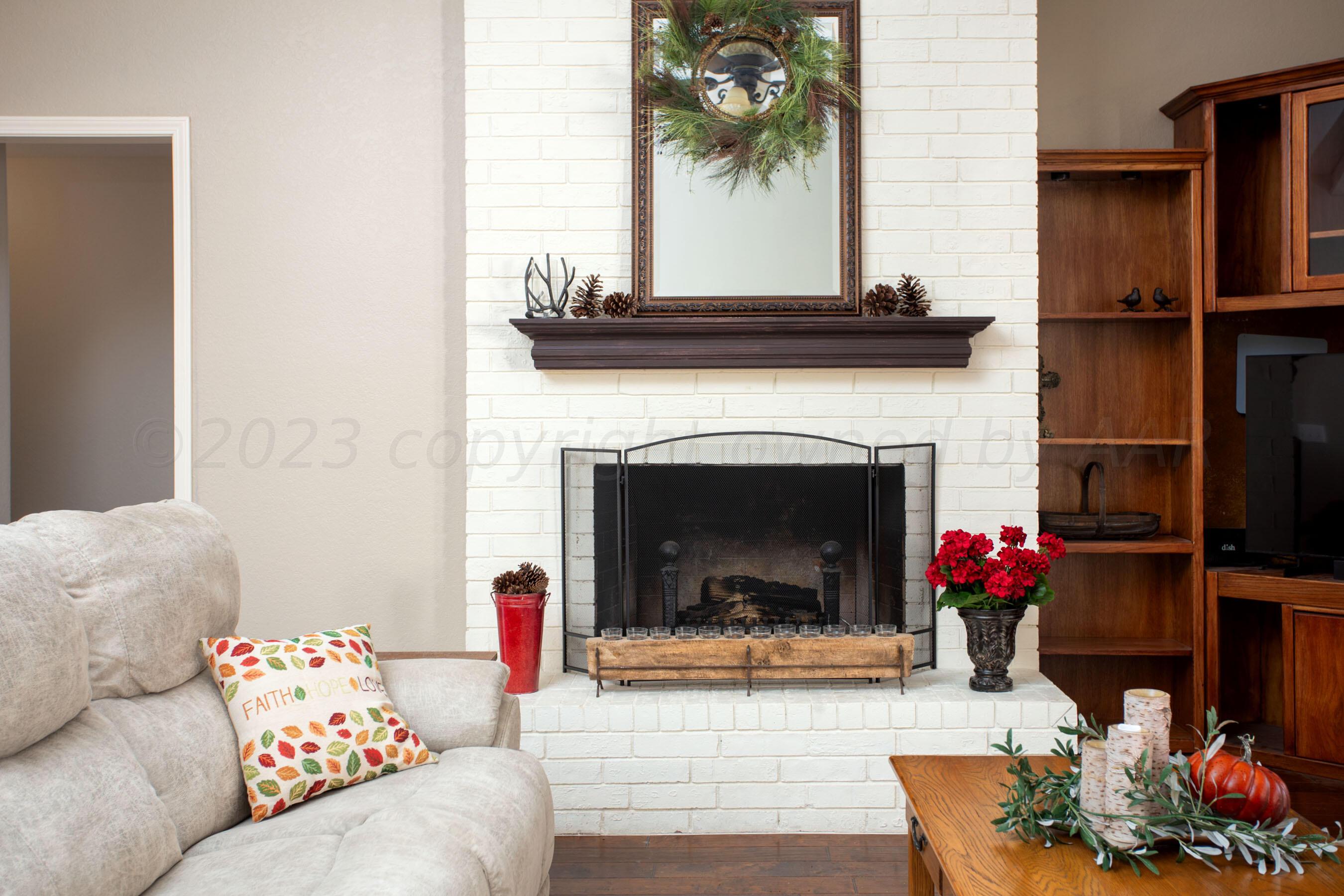 7301 Smoketree Drive Amarillo, TX 79124 - Photo 7 of 37 a living room with furniture and a fireplace
