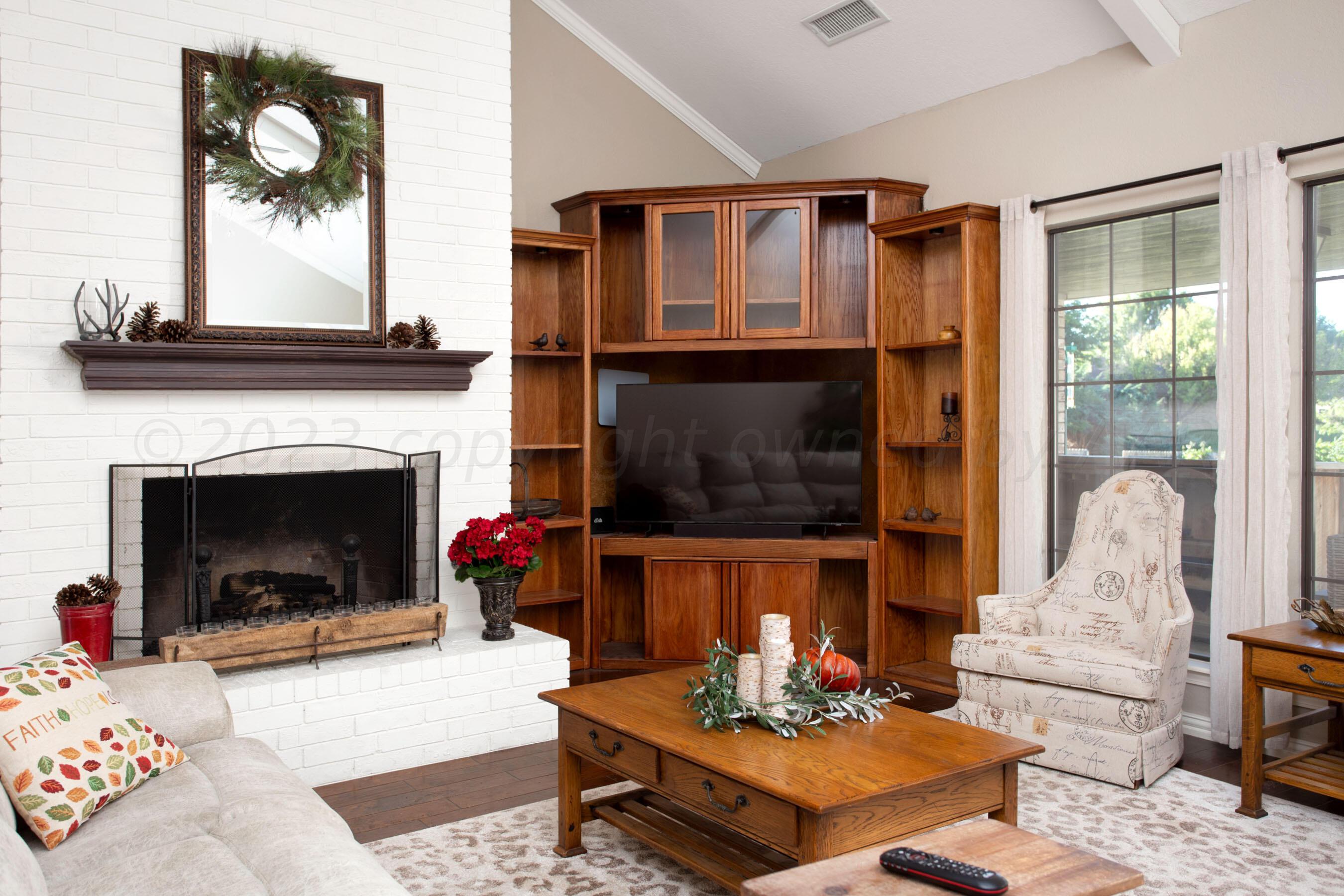 7301 Smoketree Drive Amarillo, TX 79124 - Photo 8 of 37 a living room with furniture and a fireplace