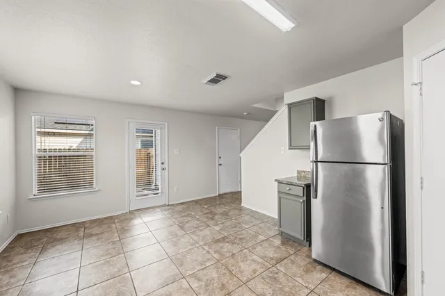 a view of an empty room with a kitchen