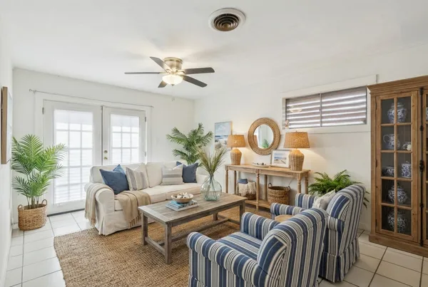 a living room with furniture a chandelier and a window